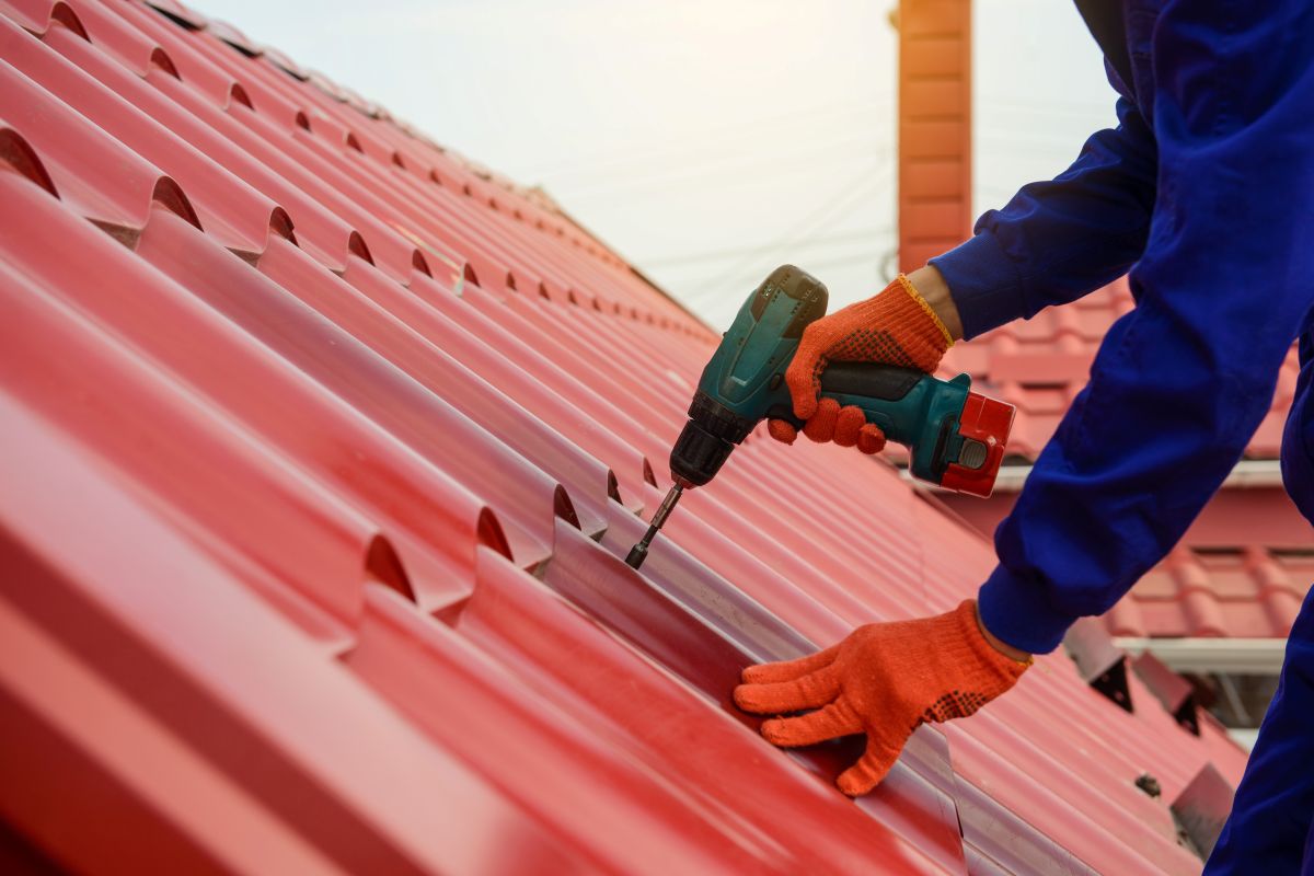 worker using tool to adjust roof