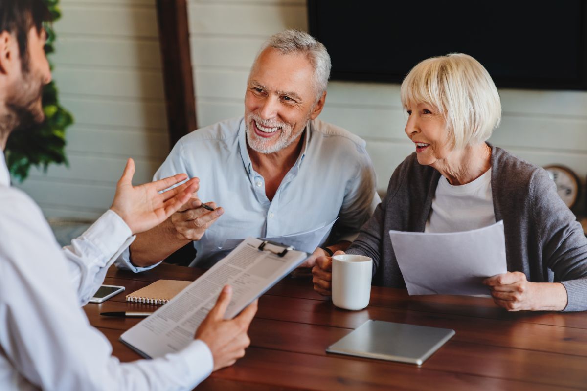 older couple consulting man holding paper