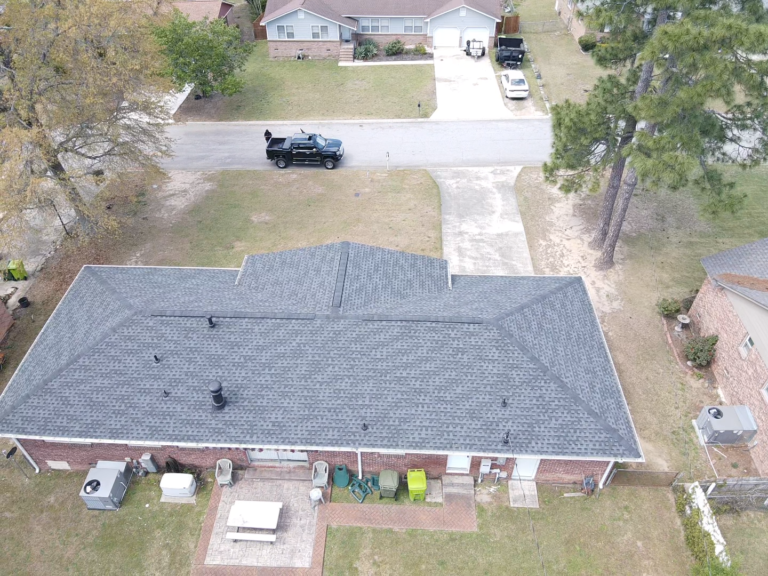 Aerial view of a house with a new shingle roof