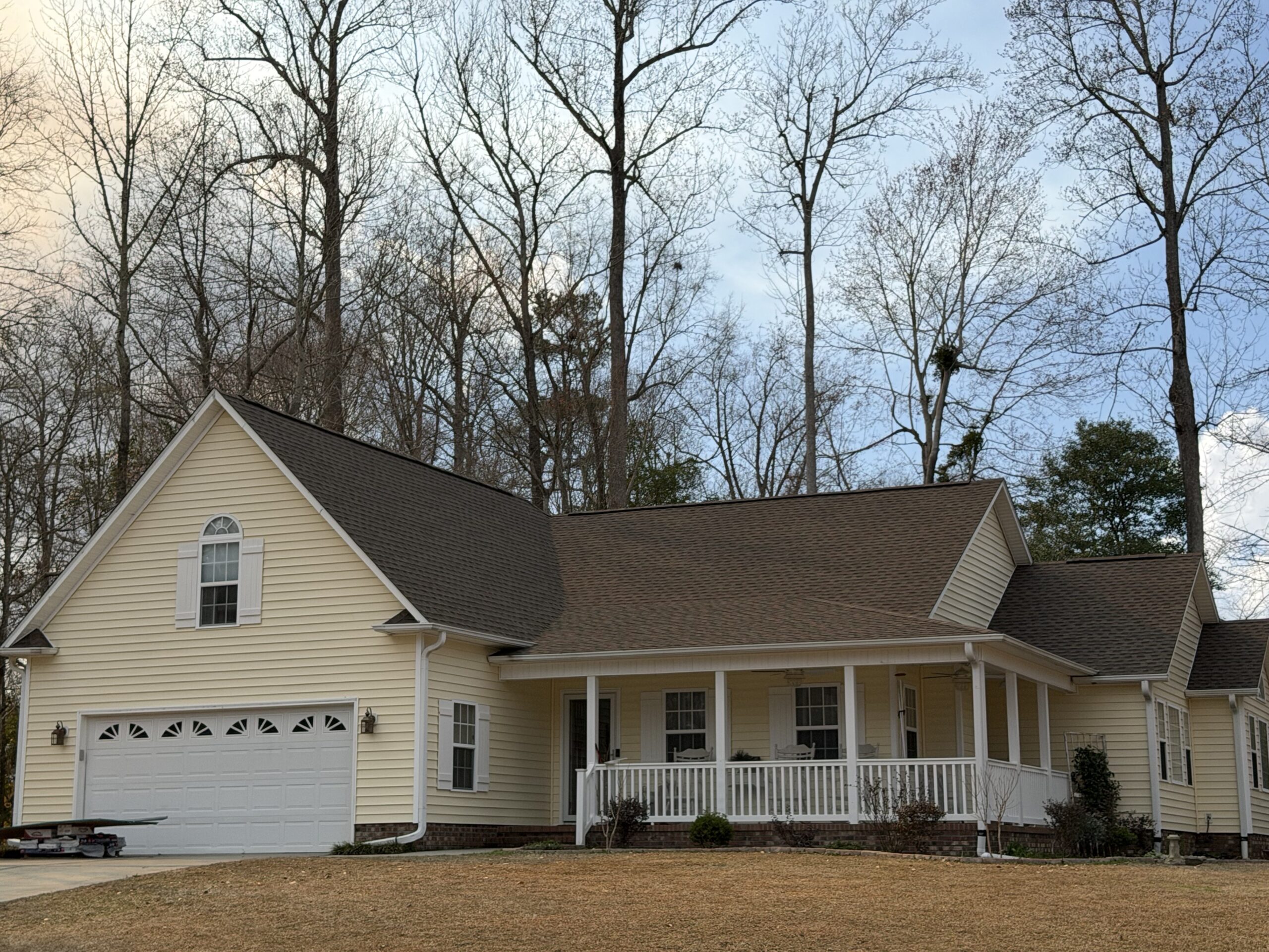 A pale yellow house with a roof by Stormgrade
