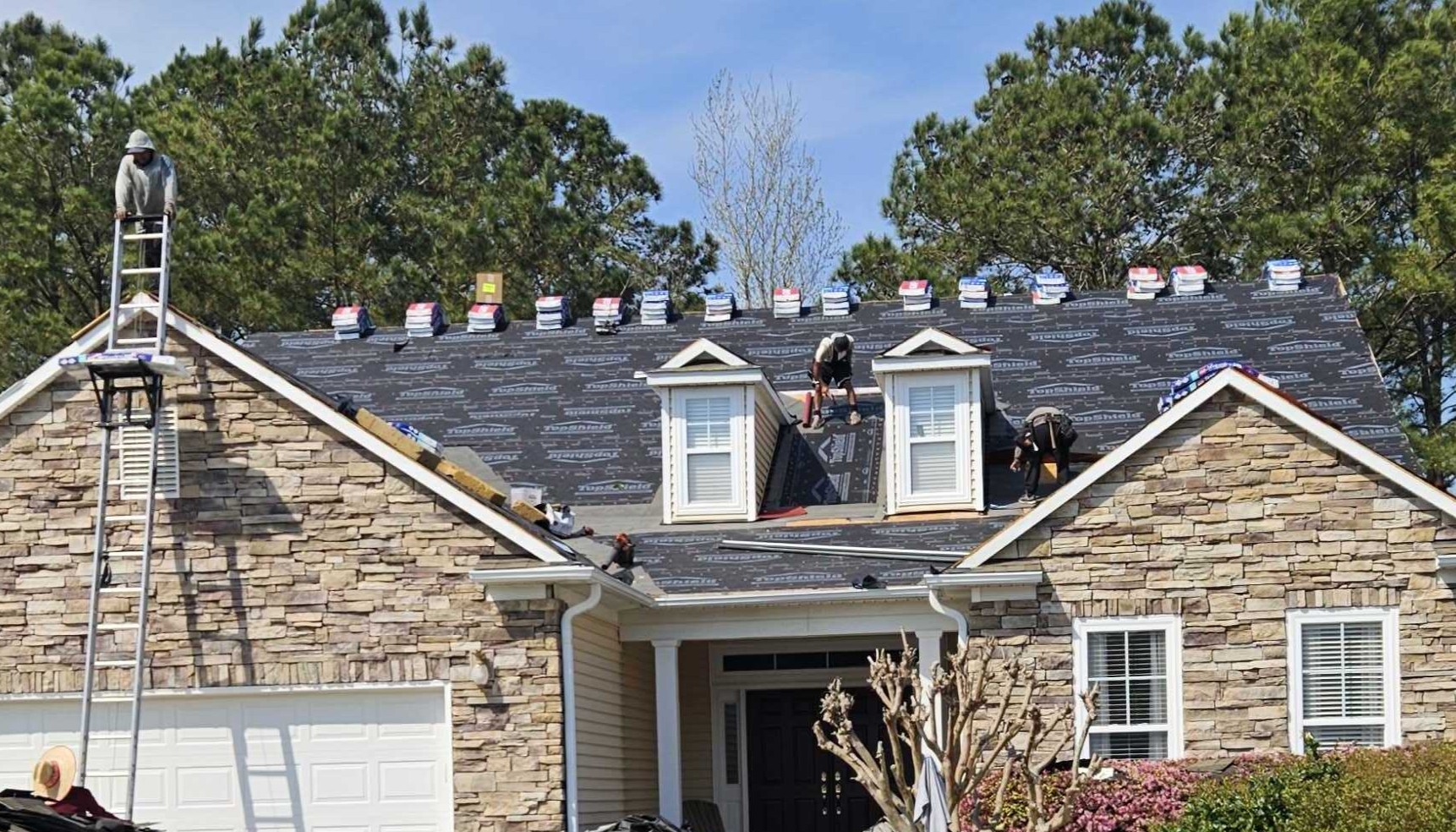 The Stormgrade team working on a roof