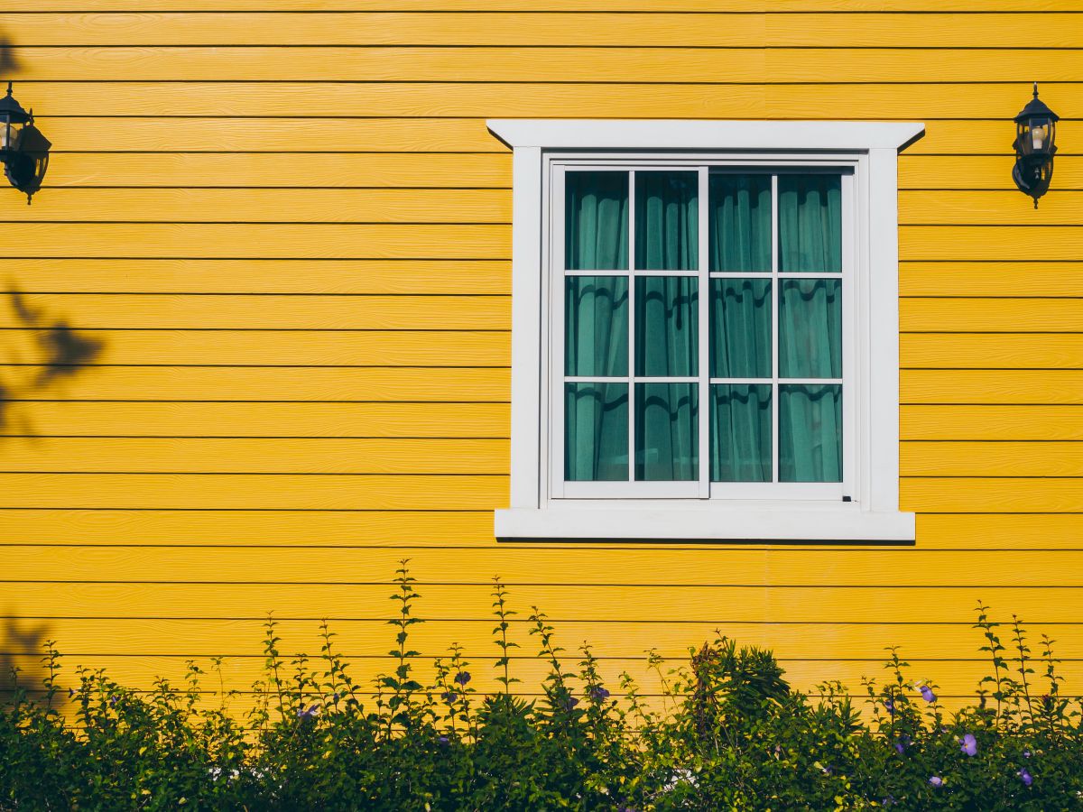 bright yellow house with a white window