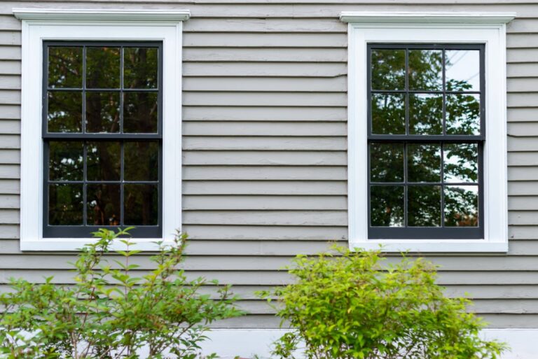 green gray house with white windows