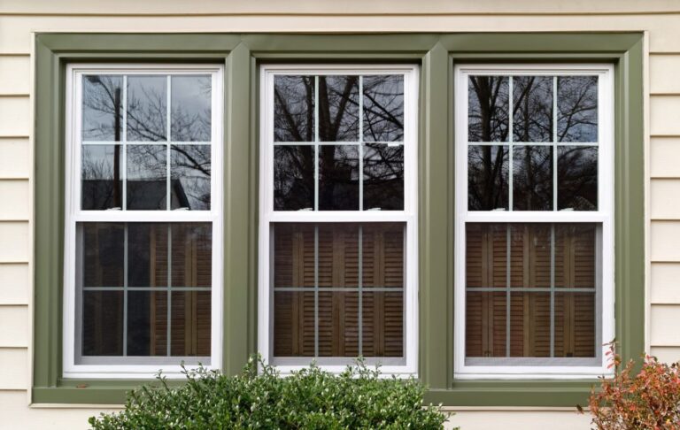 white house with white windows and green trim