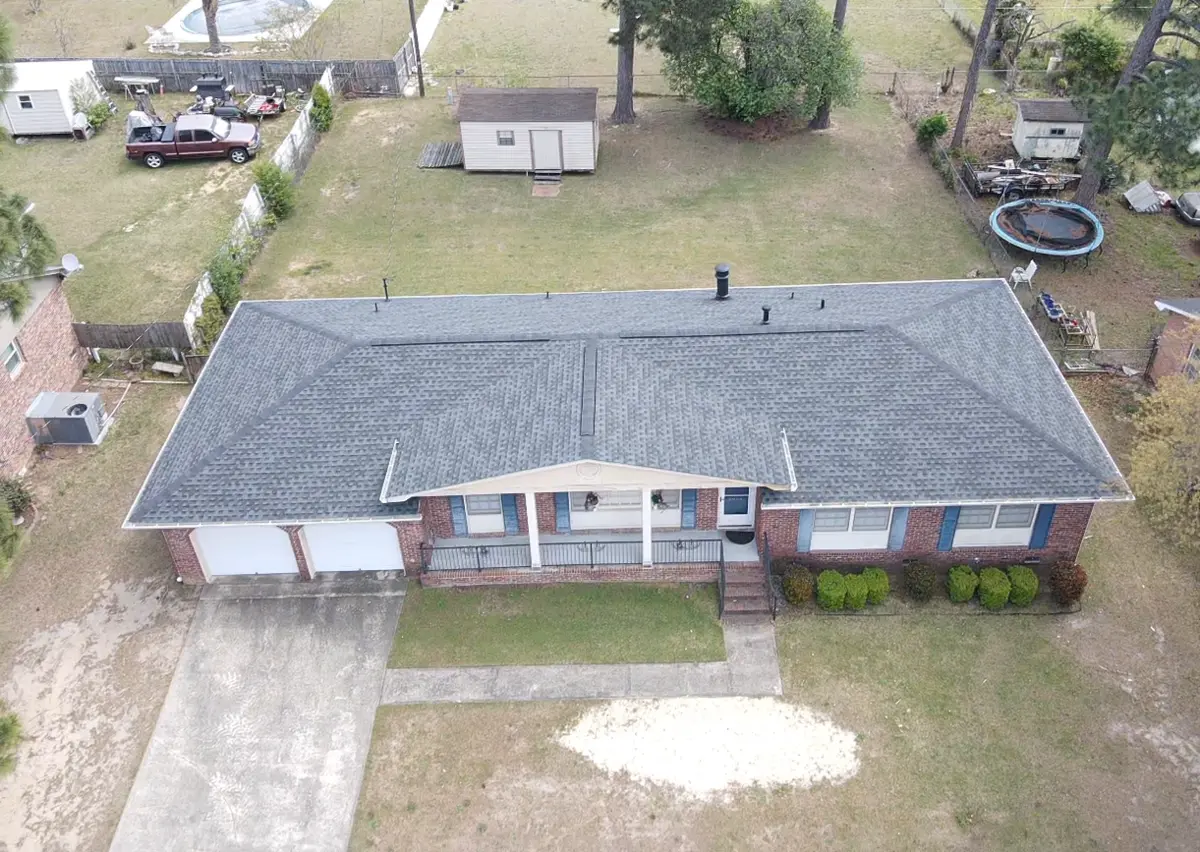 Aerial view of a house with a grey shingle roof