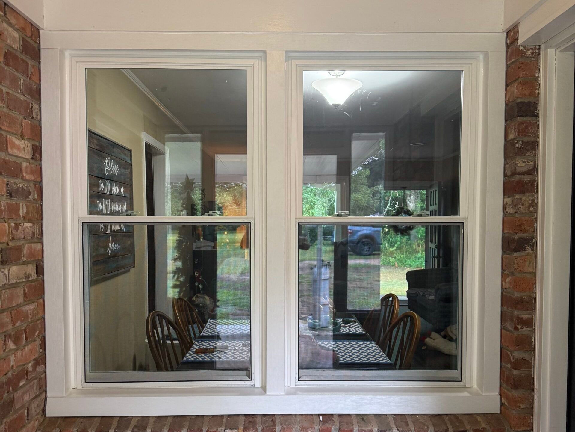 residential window repair white frame brick wall