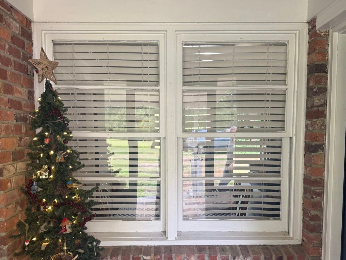 missing shingles white frame interior window Christmas tree  
