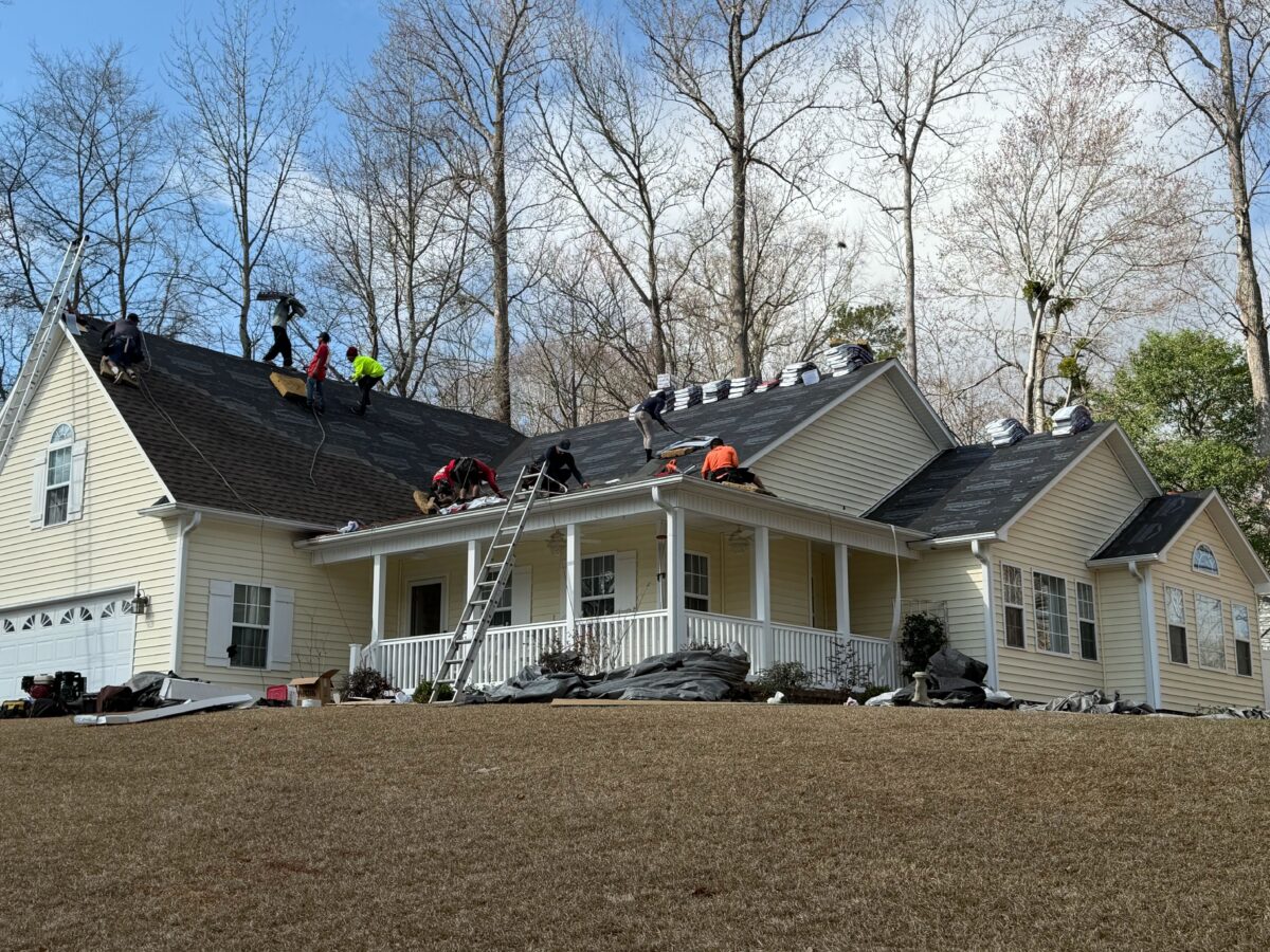 missing shingles workers fixing roof