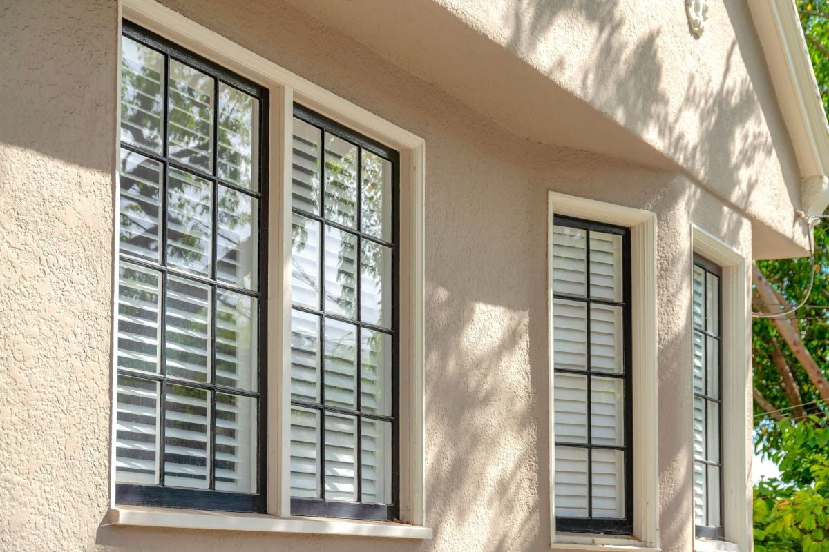 residential window repair beige wall sunny day
