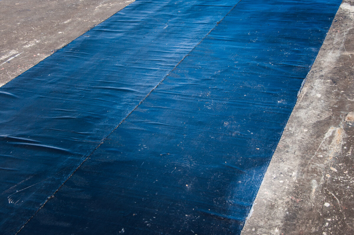 synthetic roofing underlayment Installing new waterproofing materials on the roof. Installation of waterproofing at a construction site. Protection of the roof of the building from water leakage.