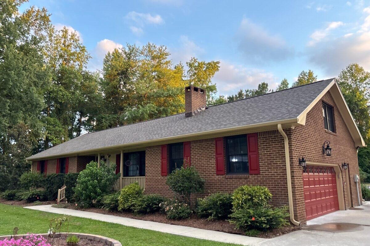 what are eaves grey shingles orange brick wall
