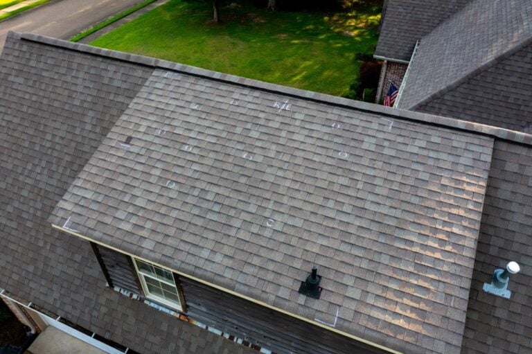 Aerail view of a roof with hail damage and markings from inspection
